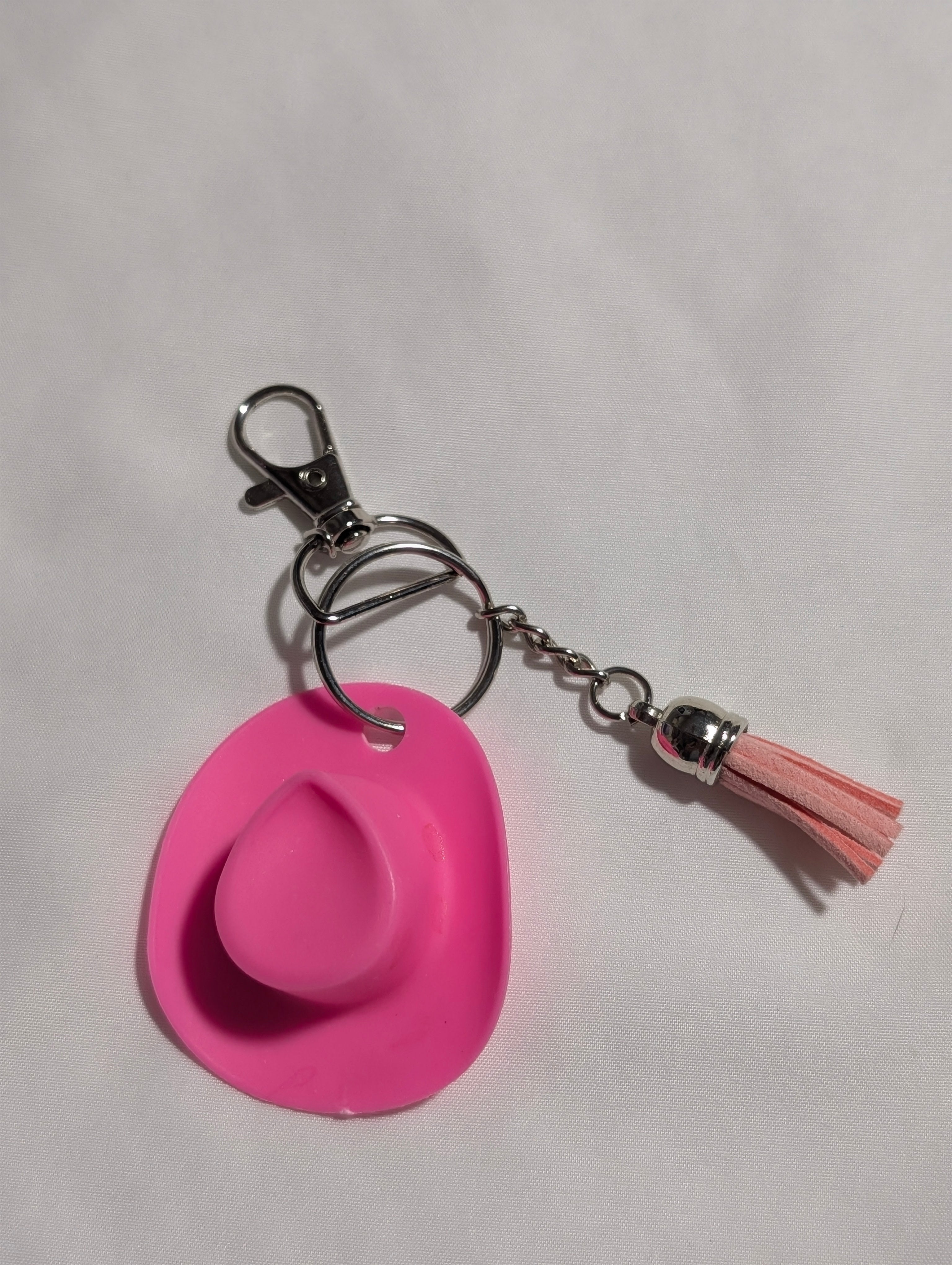 Pink cowboy hat keychain with blush tassel on silver hardware